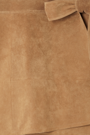 Iconic Tan Suede Mini Jaspre Skirt close-up highlighting the wrap waist tie and texture.