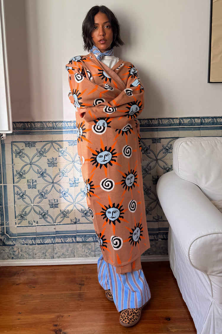 Tan Sun Cardigan with hand-painted sun and swirl motifs in an oversized longline knit silhouette.