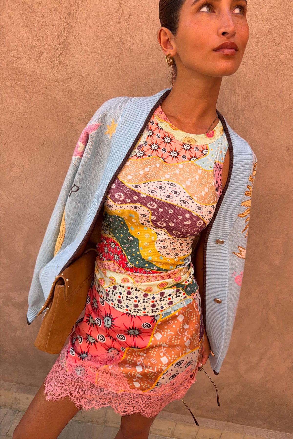 Pastel Morocco Rib Tank Top featuring palm and eye motifs, layered with a light blue cardigan and pink lace trim skirt.