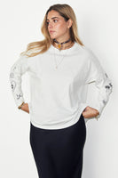 Thumbnail for caption_Model wears White Long Sleeve Tattoo T-Shirt in UK size 8/ US 4