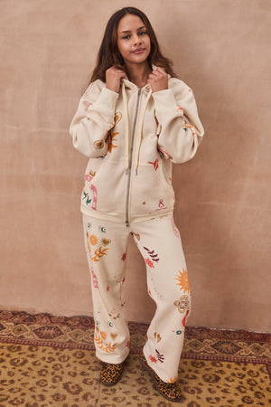 Cream Sundazed Wide Leg Accessible Joggers and matching hoodie featuring vibrant sun and heart motifs.