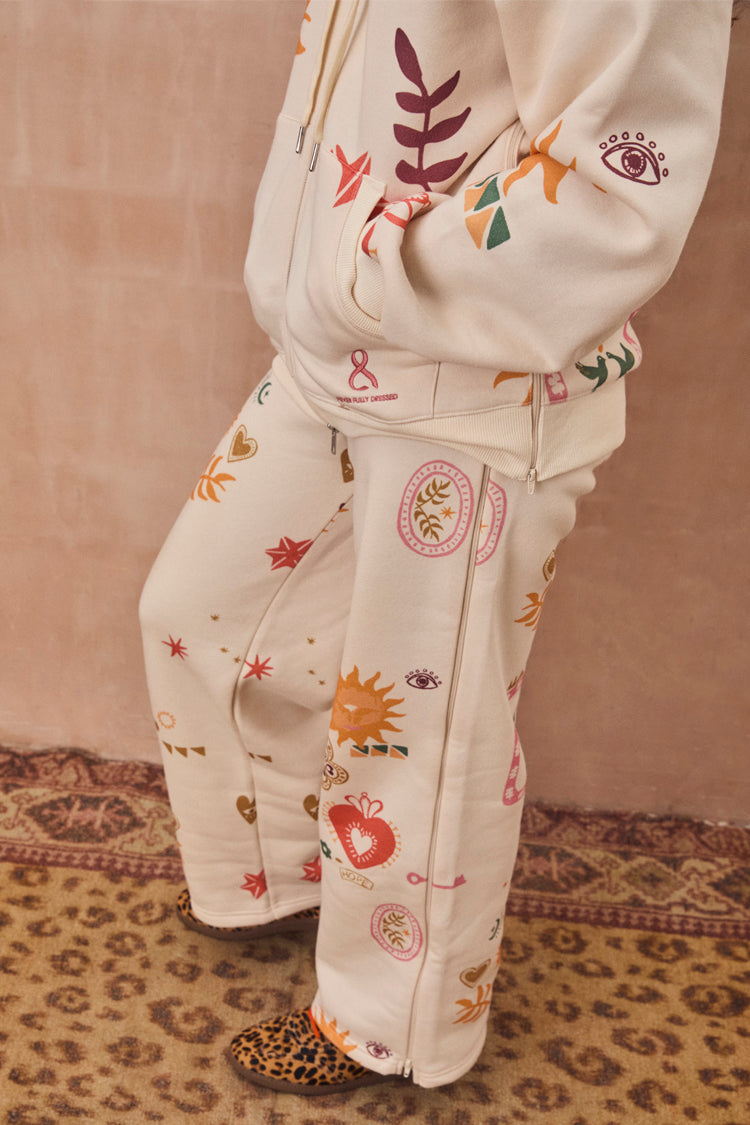 Cream Sundazed Wide Leg Accessible Joggers with iconic NFD prints and side zips for treatment access.