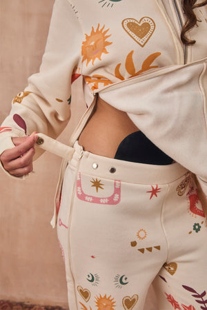 Cream Sundazed Accessible Joggers featuring side zips and poppers for treatment access and iconic prints.