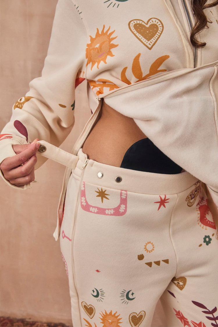 Cream Sundazed Accessible Joggers featuring side zips and poppers for treatment access and iconic prints.