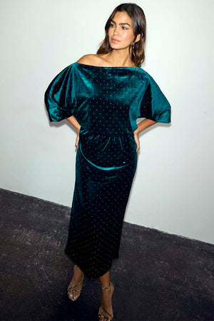 Emerald Velvet Tilly Dress with an off-the-shoulder neckline and diamante details, worn by a model.