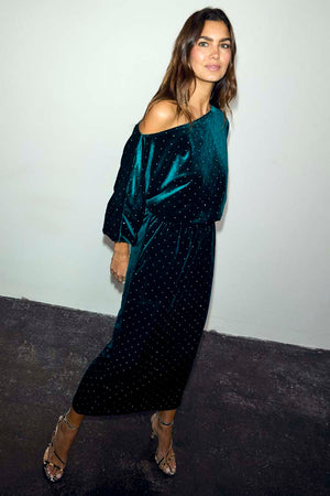 Emerald Velvet Tilly Dress featuring a green velvet fabric with sparkly dots and an off-the-shoulder neckline.