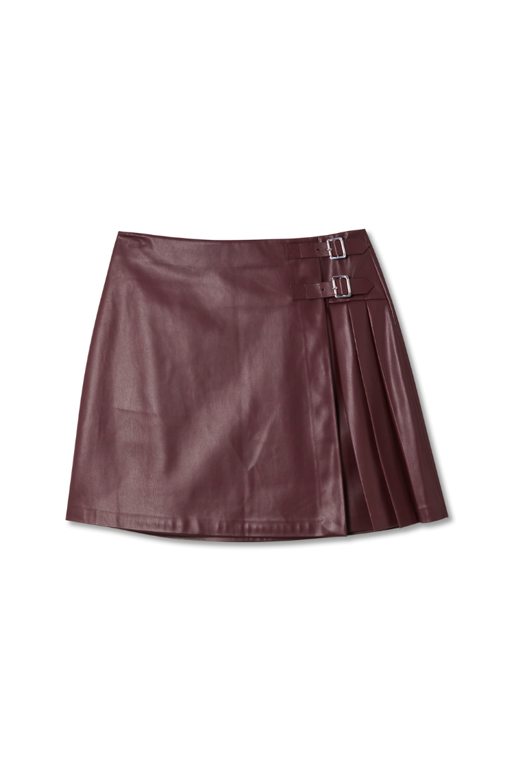 Burgundy vegan leather mini kilt skirt featuring pleated side detailing and silver-tone buckle fastenings.