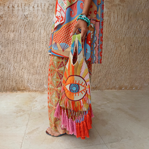 Dolce Vita Eye Bag featuring a multicoloured glass bead eye motif and long pink and orange tassels.