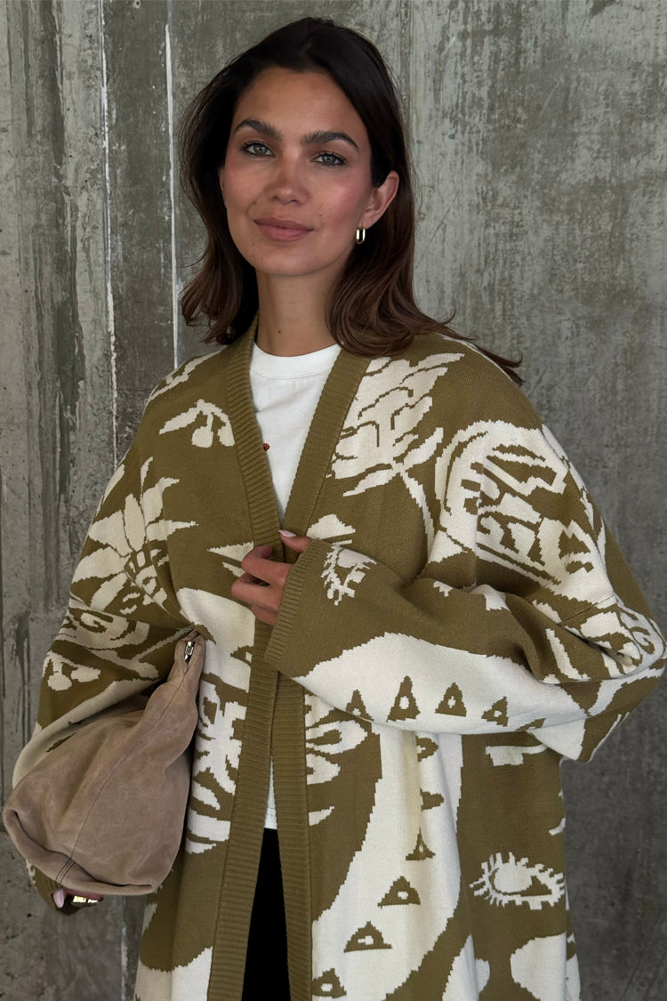 Olive Amara Knit Coatigan in khaki with white eye and flower motifs, styled with a tan suede bag.