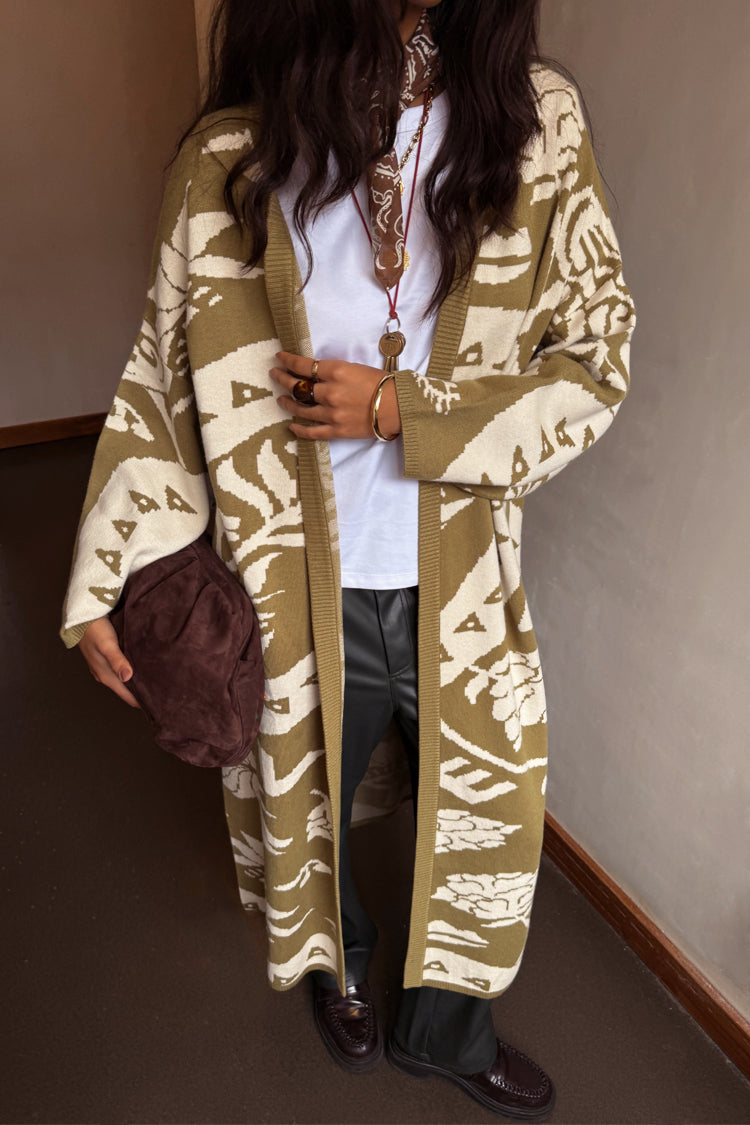 Olive Amara Knit Coatigan featuring cream heart and eye motifs in an oversized longline silhouette.