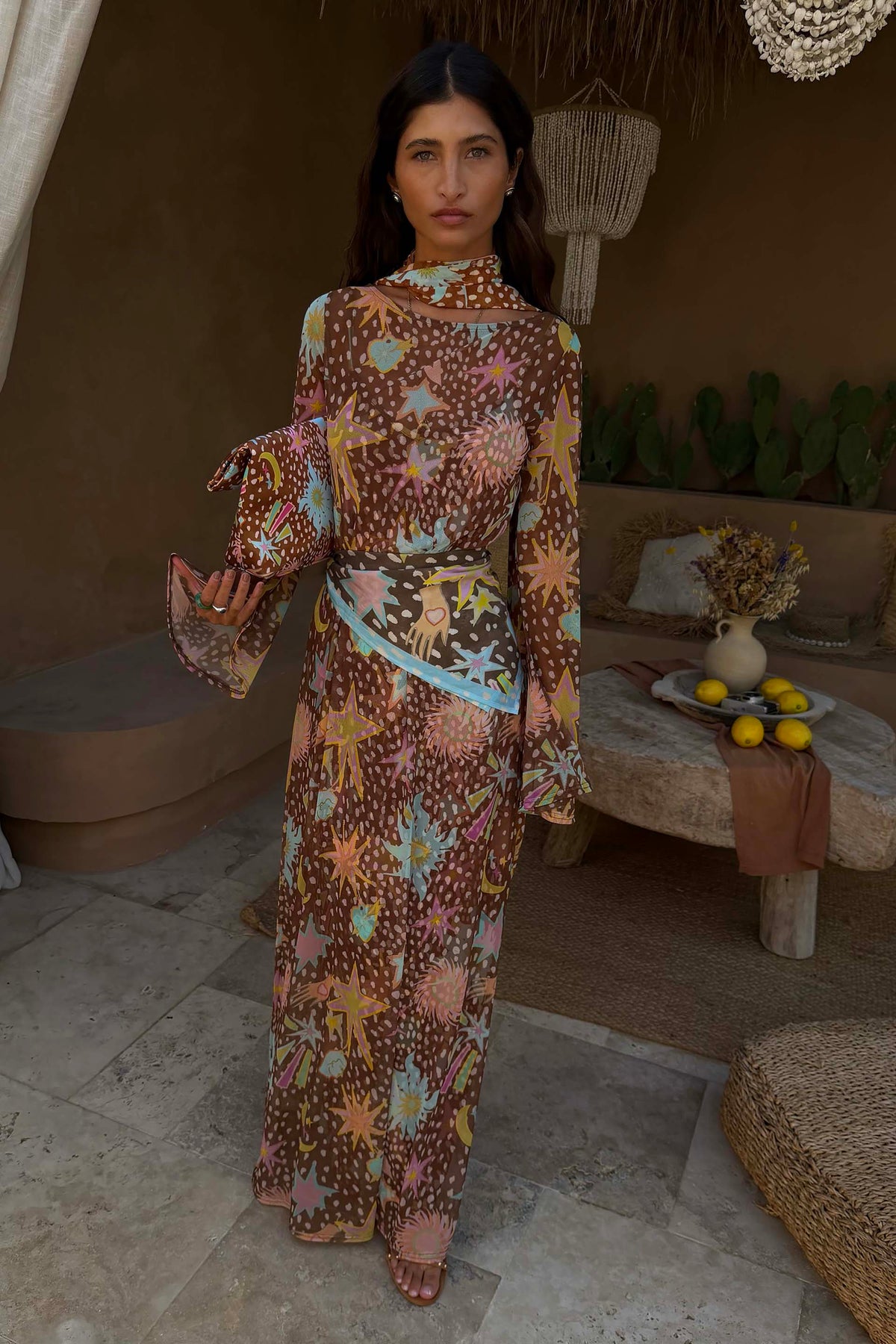 Brown Star Fawn Aria Mesh Dress with celestial motifs and flared sleeves on a model.