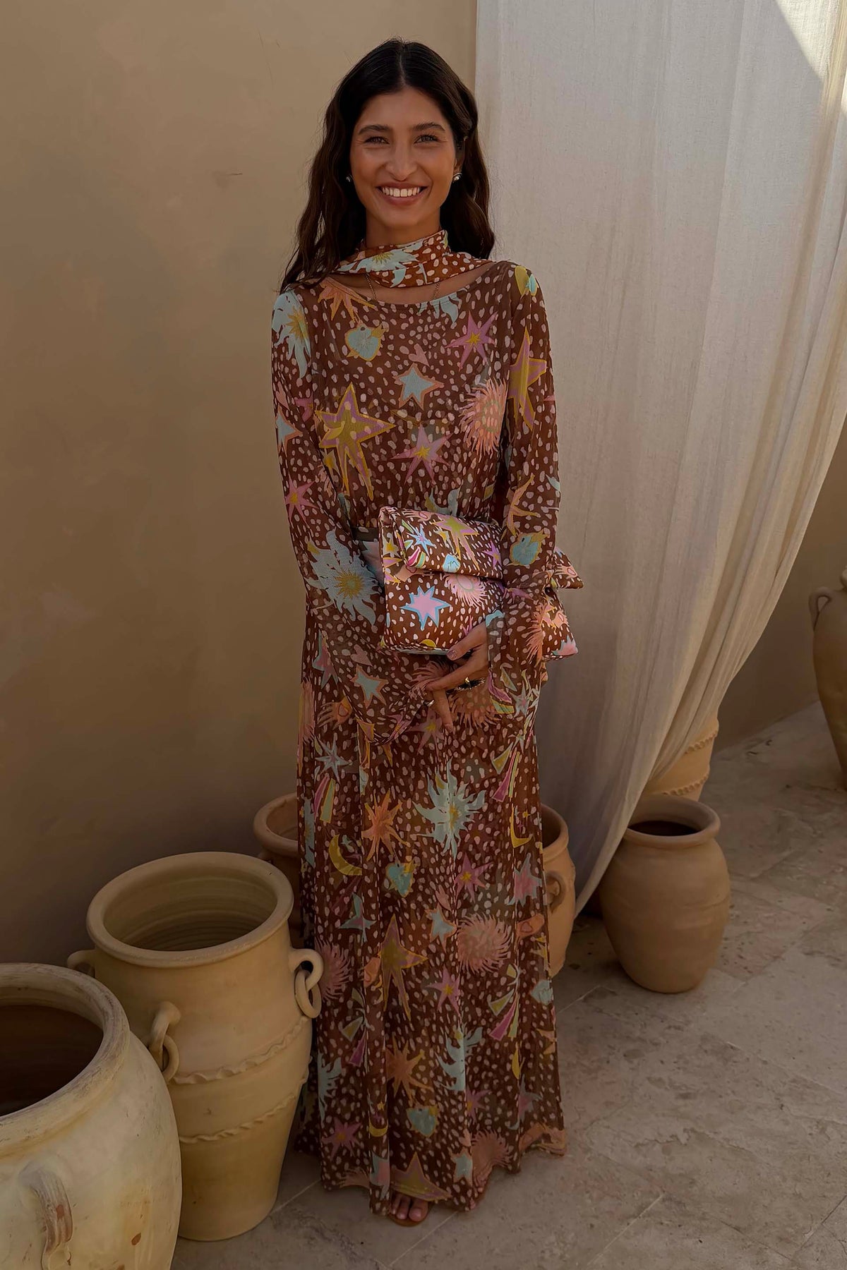 Star Fawn Aria Mesh Dress in brown with sun and star motifs, featuring flared sleeves and a matching scarf.