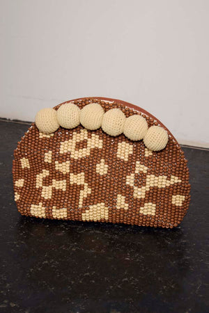 Jaden Beaded Clutch Bag featuring brown and cream leopard print beading and large cream crochet pom-poms.