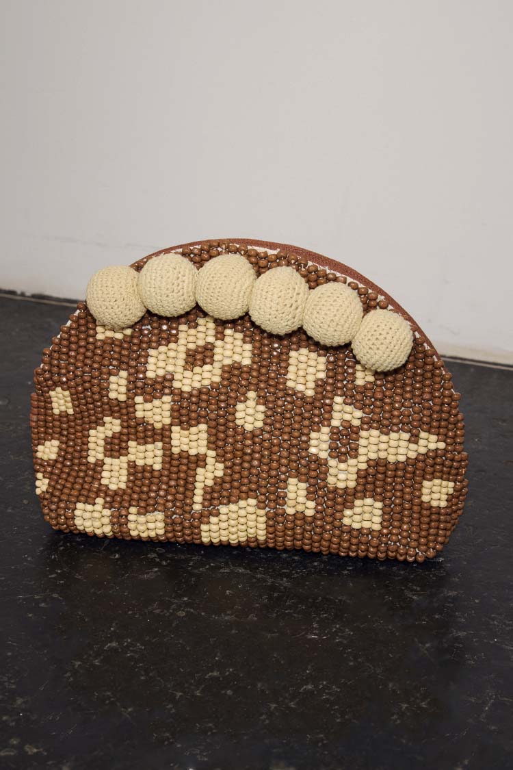 Jaden Beaded Clutch Bag featuring brown and cream leopard print beading and large cream crochet pom-poms.
