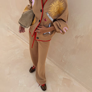 Camel Wide Leg Joggers with red trim and drawstring, paired with a sun-embroidered cardigan and leopard trainers.