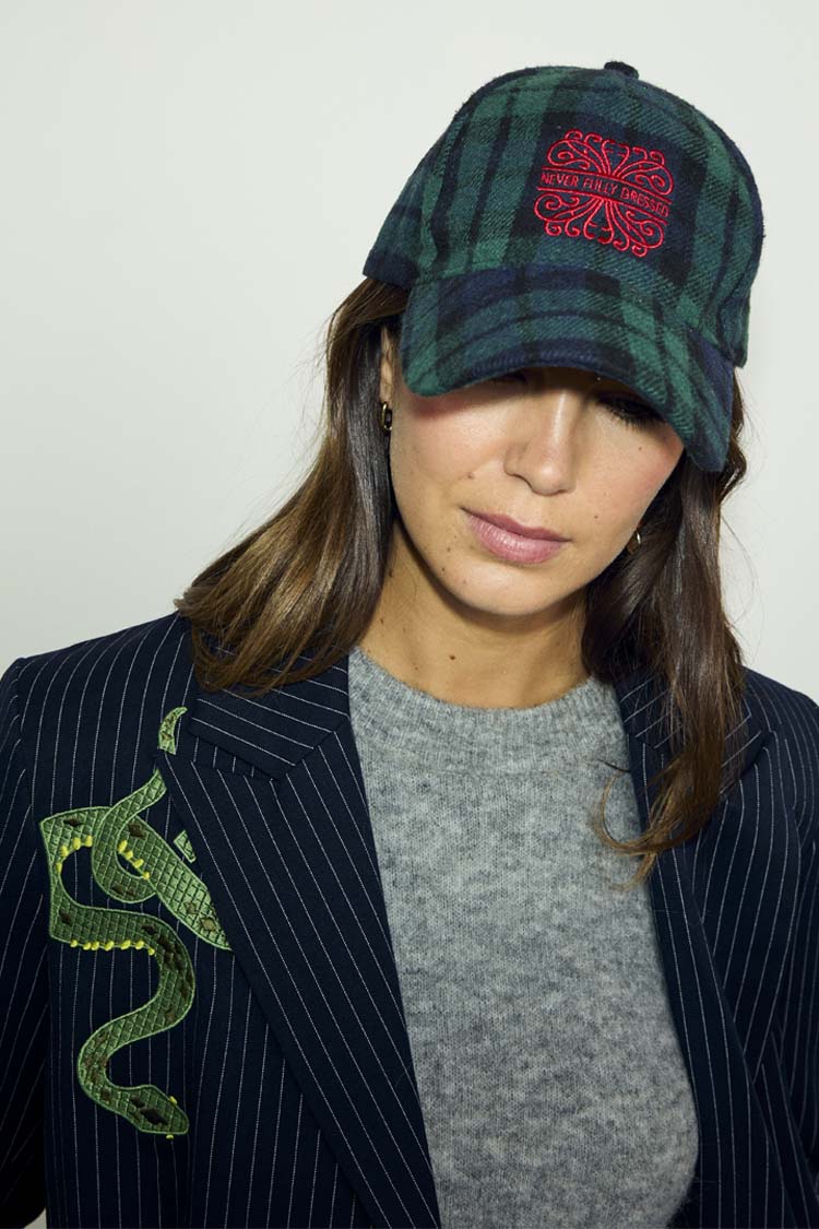 Navy Tartan NFD Cap in blue and green with red embroidered logo, styled with a grey knit and pinstripe blazer.