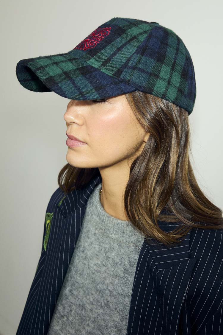 Navy Tartan NFD Cap featuring blue and green checks and a red embroidered logo, styled with a pinstriped blazer.