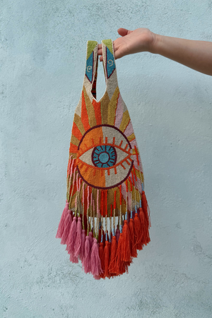 Dolce Vita Eye Bag with an iconic beaded eye motif, multicoloured glass beads and vibrant pink and orange tassels.