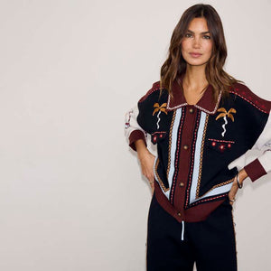 Geometric Knit Cardigan in autumnal tones with palm motif embroidery and blanket stitch trim, paired with joggers.