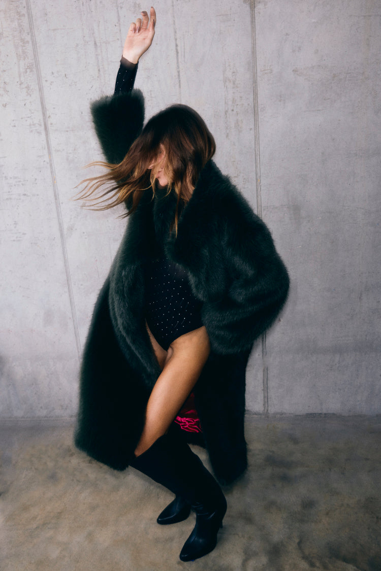 Green Faux Fur Coat in a relaxed silhouette, styled over a black bodysuit for a statement look.