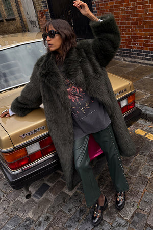 Bottle Green Studded Vegan Leather Trousers with side details, styled with a faux fur coat and vintage gold car.