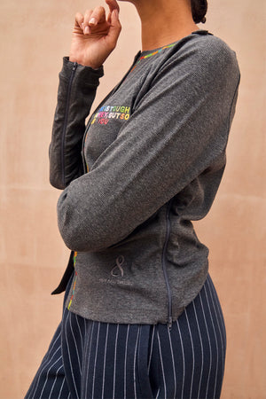 Charcoal grey Honey T-Shirt with multicoloured slogan embroidery and functional side zips for treatment accessibility.