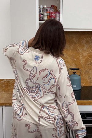 Cream Octopus Button Through Pyjamas featuring a navy and red octopus print, shown in a kitchen setting.