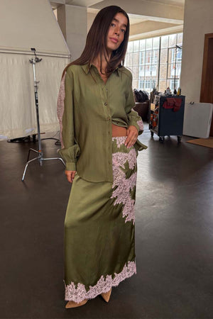 Olive & Pink Lily Skirt in satin with pink lace detailing, styled with the matching lace-sleeve shirt.