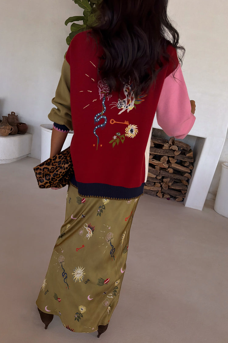 Olive Mystical Dorris Skirt in green with sun and moon motifs, styled with a colourful embroidered cardigan.