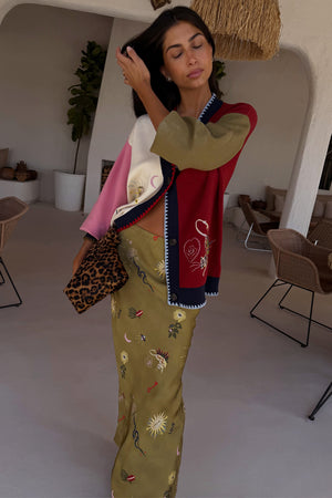 Olive Mystical Dorris Skirt with sun and moon motifs, paired with a colour-block cardigan and leopard print bag.