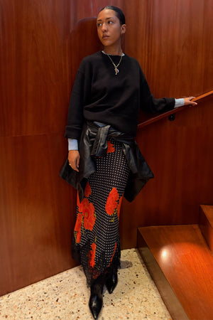 Black Poppy Midi Maeva Skirt with iconic poppy print and lace border, styled with a black jumper and leather jacket.