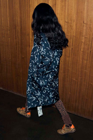 Mono Swallow Romance Reversible Coat with a black and white swallow print, shown on a model walking.