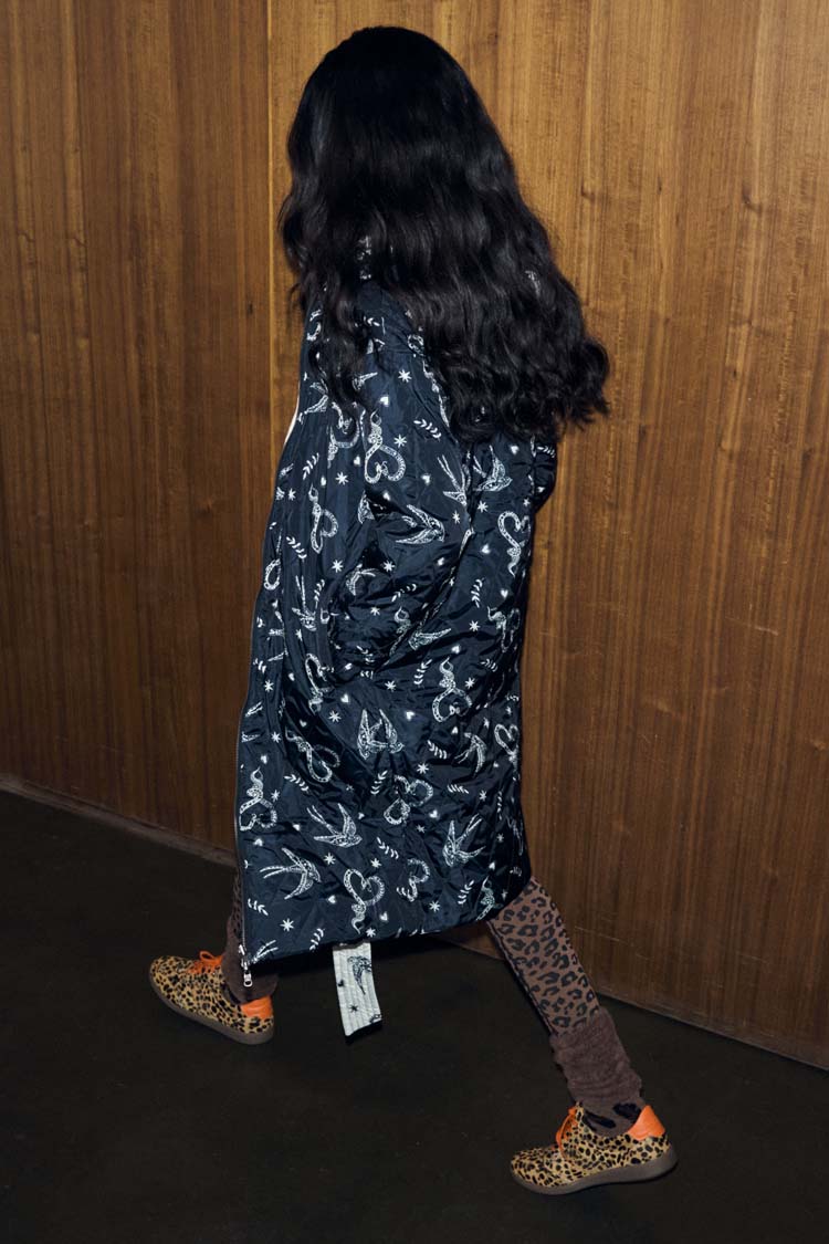 Mono Swallow Romance Reversible Coat with a black and white swallow print, shown on a model walking.