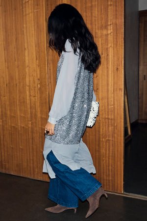 Shimmering Gunmetal Sequin Lila Shirt Dress layered over blue wide-leg denim and brown pointed boots for London looks.