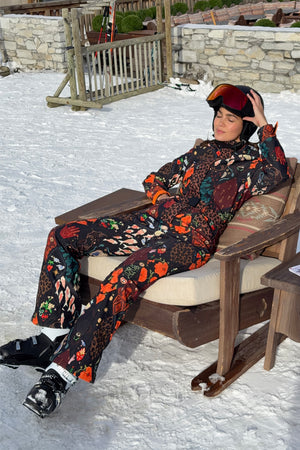 Night Garden Ski Suit in a black multi-motif print with leopard and poppy details, featuring a belted waist.