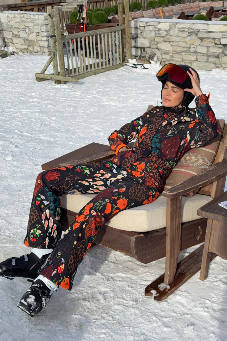 Night Garden Ski Suit in a black multi-motif print with leopard and poppy details, featuring a belted waist.