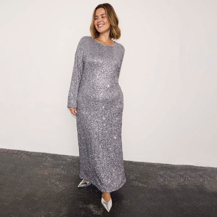 Gunmetal Sequin Soho Dress with long sleeves and a body-skimming maxi silhouette in shimmering grey sequins.