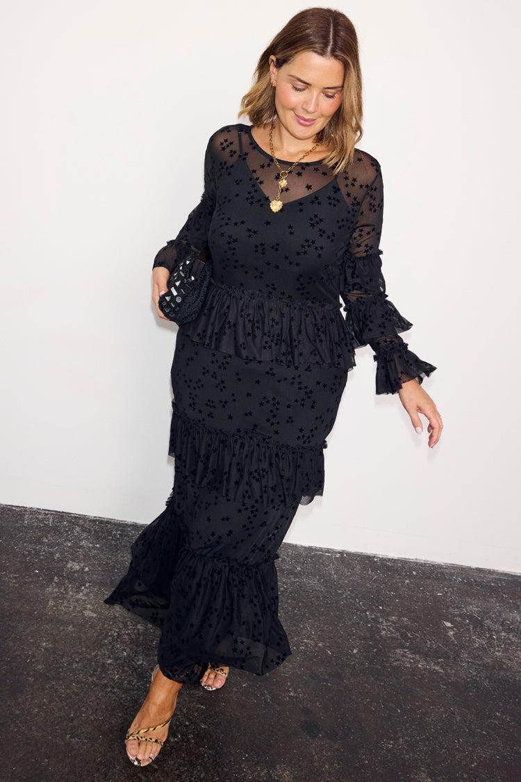 Black Star Devore Felicity Dress with tiered ruffles and velvet star motifs, worn by a size 18 model.