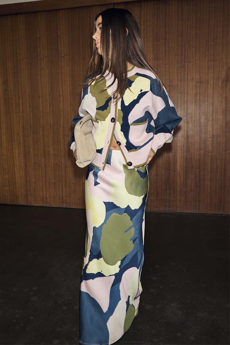 Teal Mara Abstract Cheryl Cardigan featuring a pink and green artist print, worn as a co-ord with a matching maxi skirt.