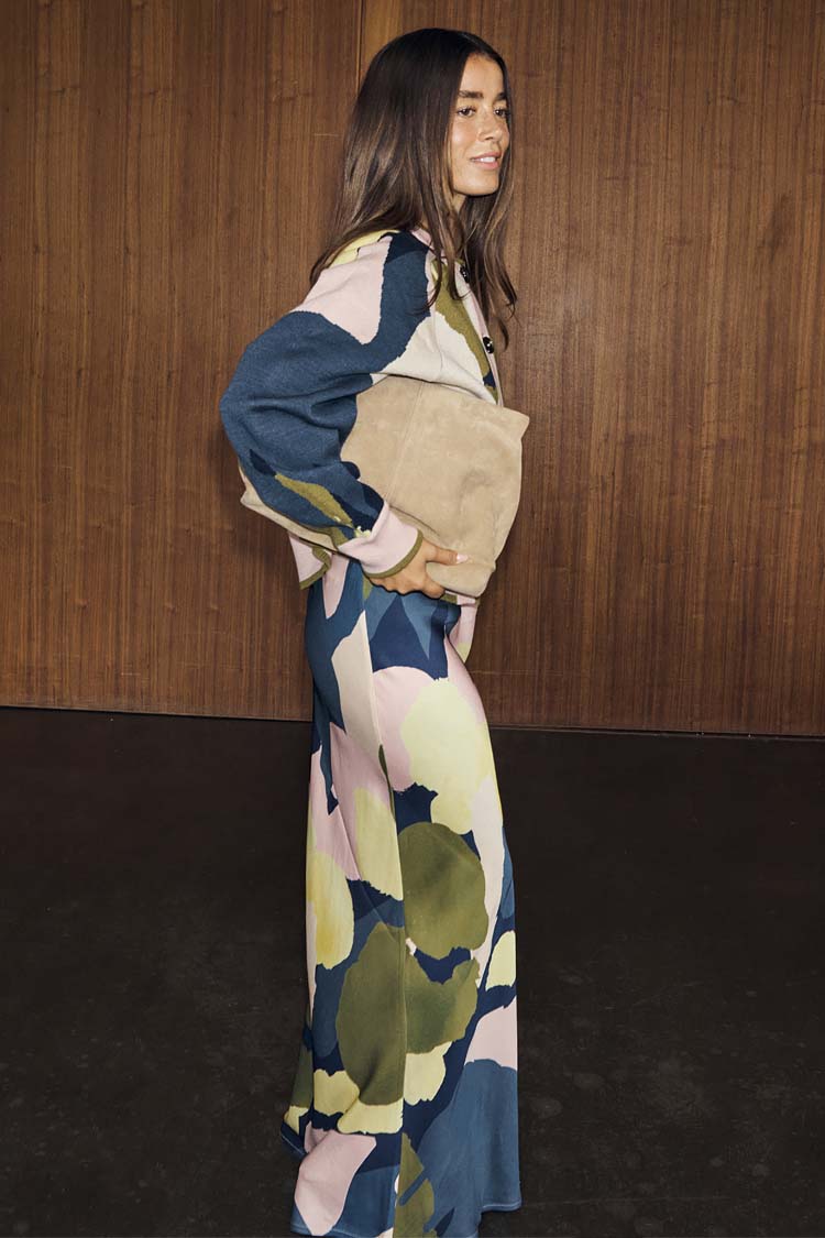 Teal Mara Abstract Dorris Skirt with a pink and olive print, styled as a co-ord with a matching top and tan clutch bag.