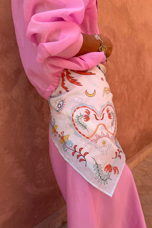 Cream Bandana in Tigress Print with heart and eye motifs, tied around the waist as a multi-wear accessory.