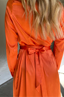 Thumbnail for Model wearing Orange Long Sleeve Wrap Midi Dress facing away from the camera