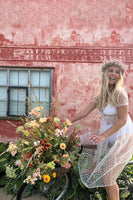 Thumbnail for Model wearing White Heart Flocked Billie Dress sitting on a bike