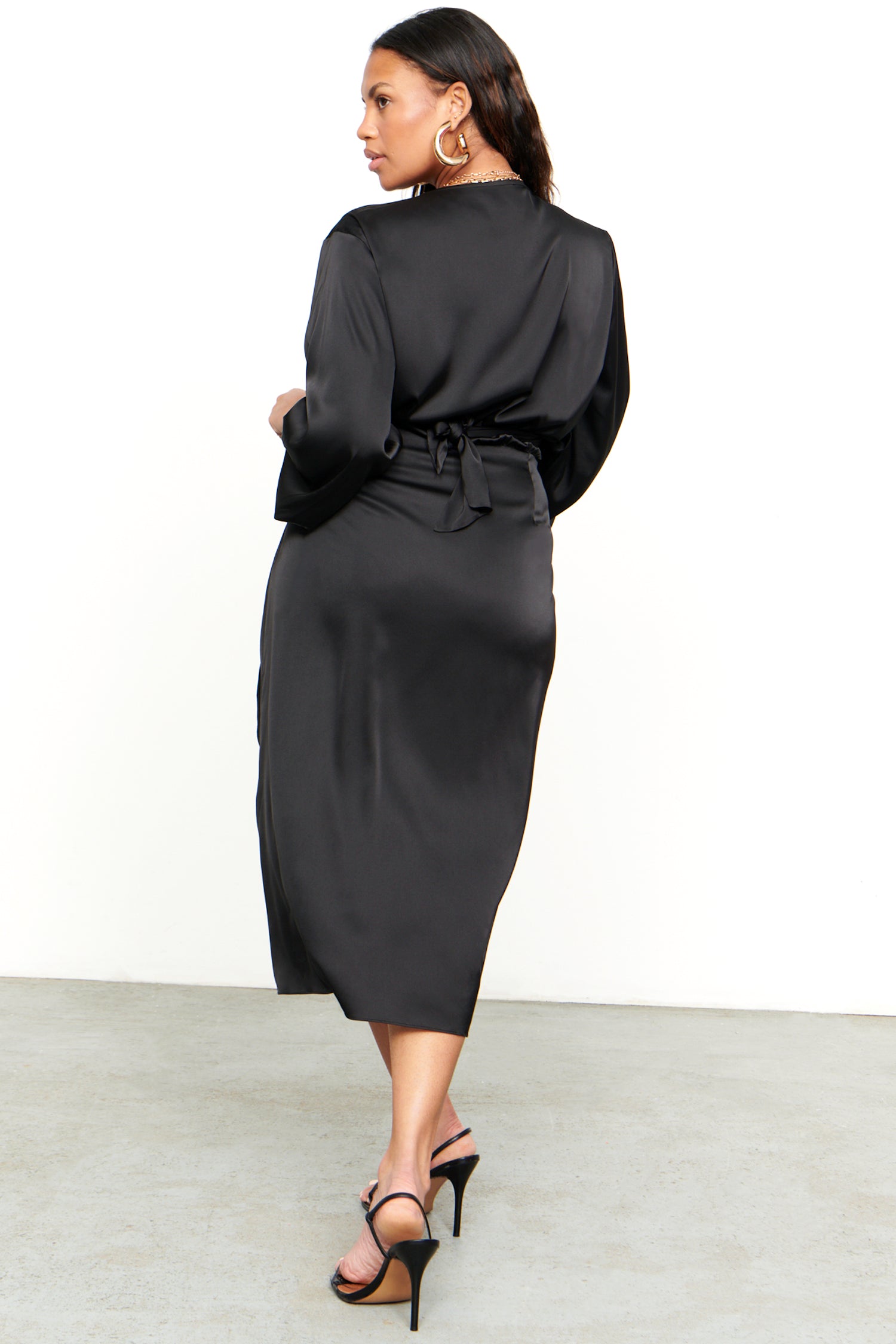 Model wearing Black Midi Vienna Dress standing facing away from the camera