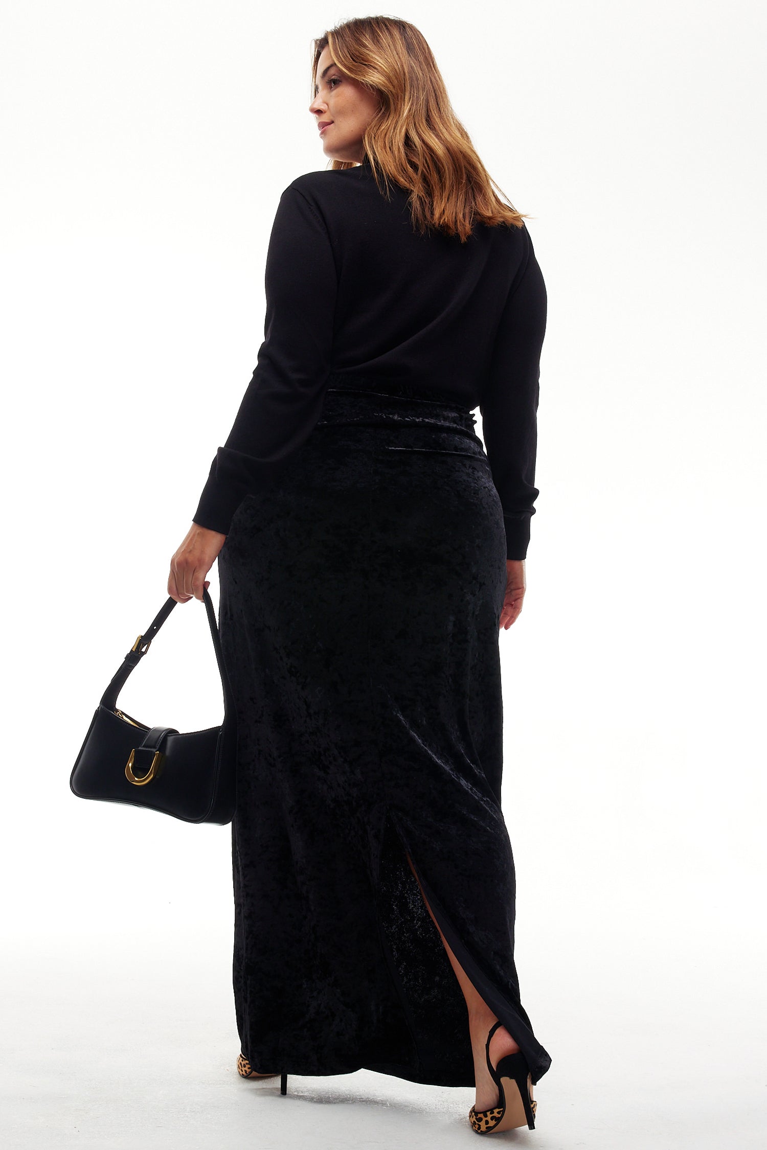 Model wearing Black Velvet Maxi Dress standing facing away from the camera