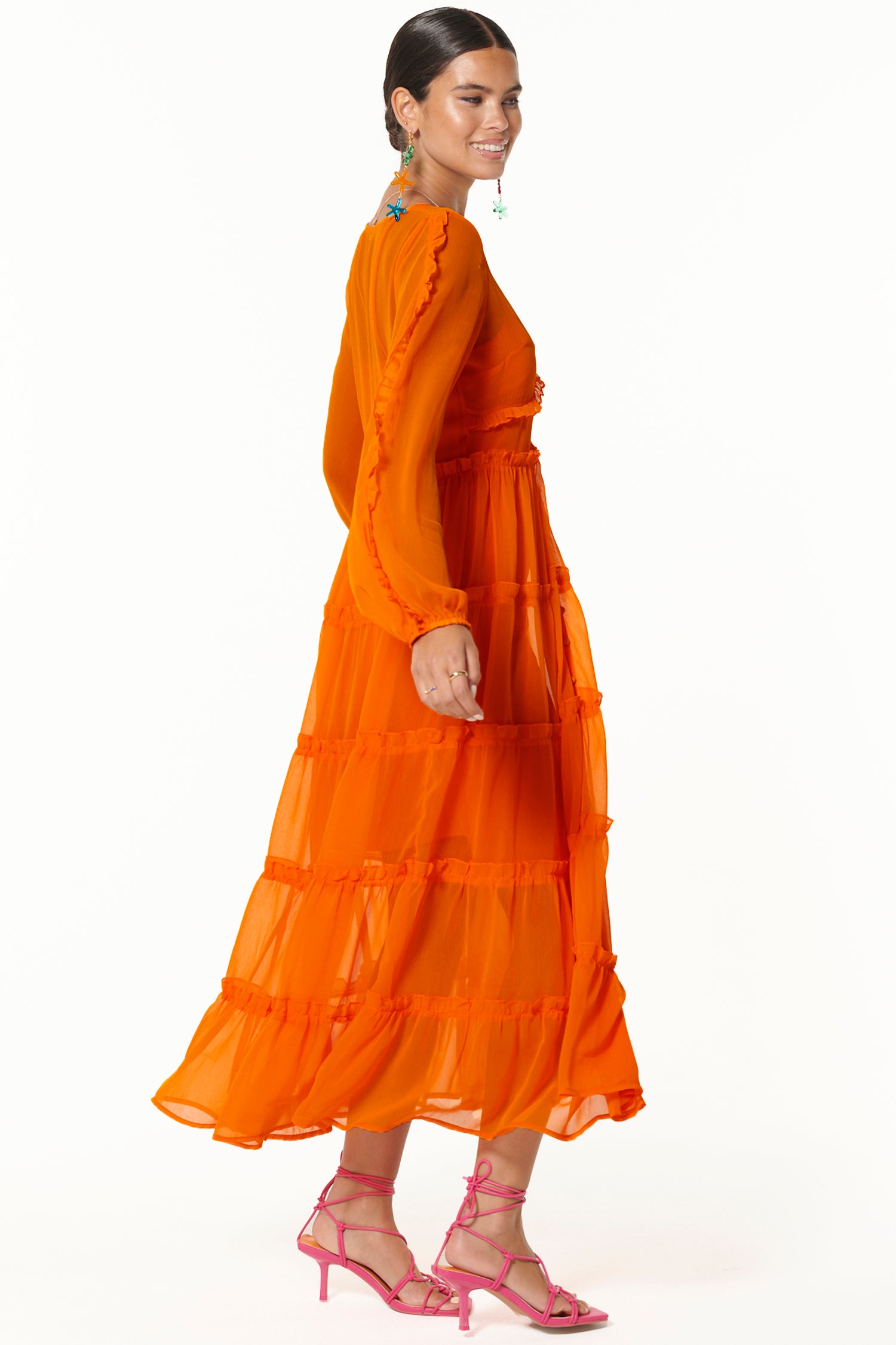 Model wearing Orange Clemmie Dress side shot