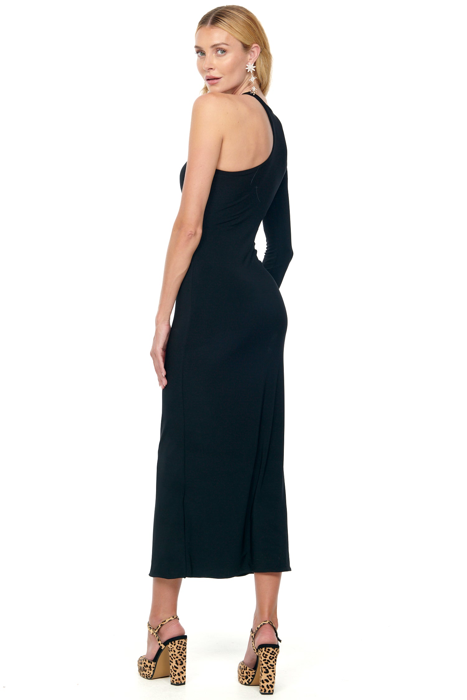Model wearing Black Midi Gigi Cut Out Dress standing facing away from the camera