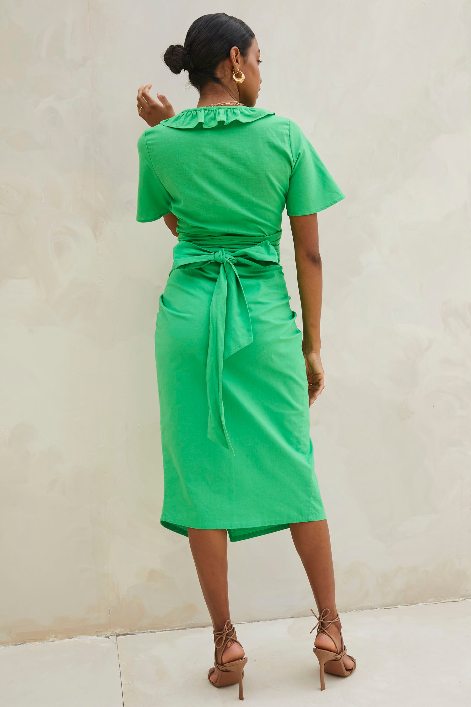 Model wearing Green Cotton Linen Roma Top standing facing away from  the camera