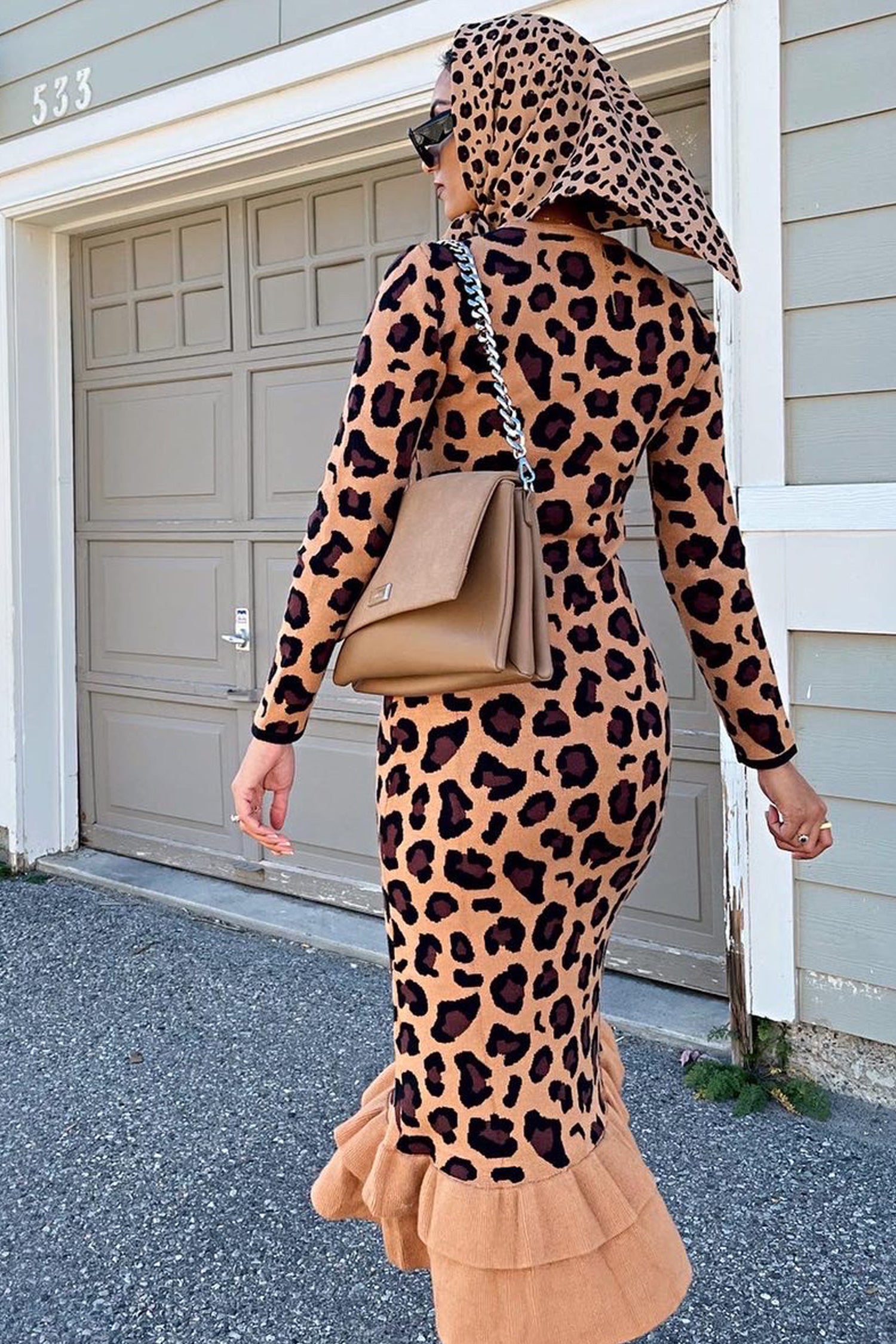 Model wearing Leopard Headscarf standing facing away from the camera