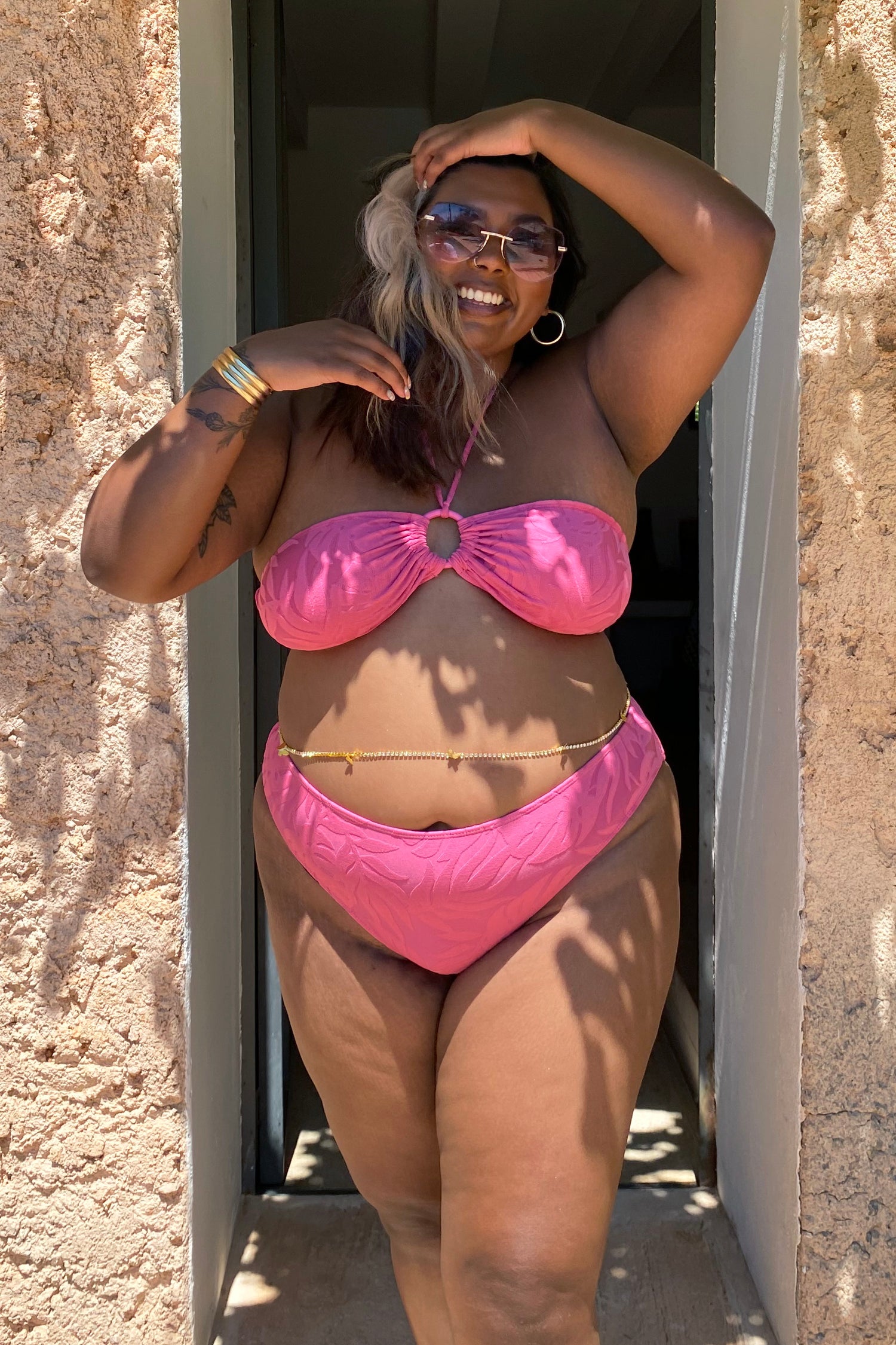 Model wearing Pink Palm Bikini Top standing facing the camera